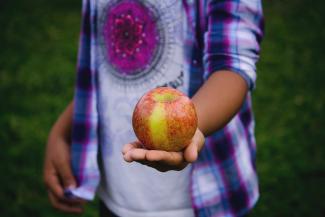 Giving an apple.