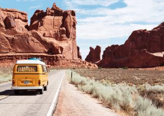 Yellow Volkswagen van on road in desert