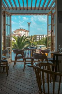 a patio with tables and chairs by Alex jiang courtesy of Unsplash.