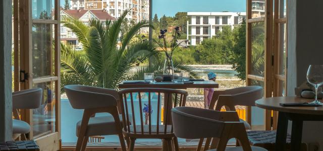 a patio with tables and chairs by Alex jiang courtesy of Unsplash.